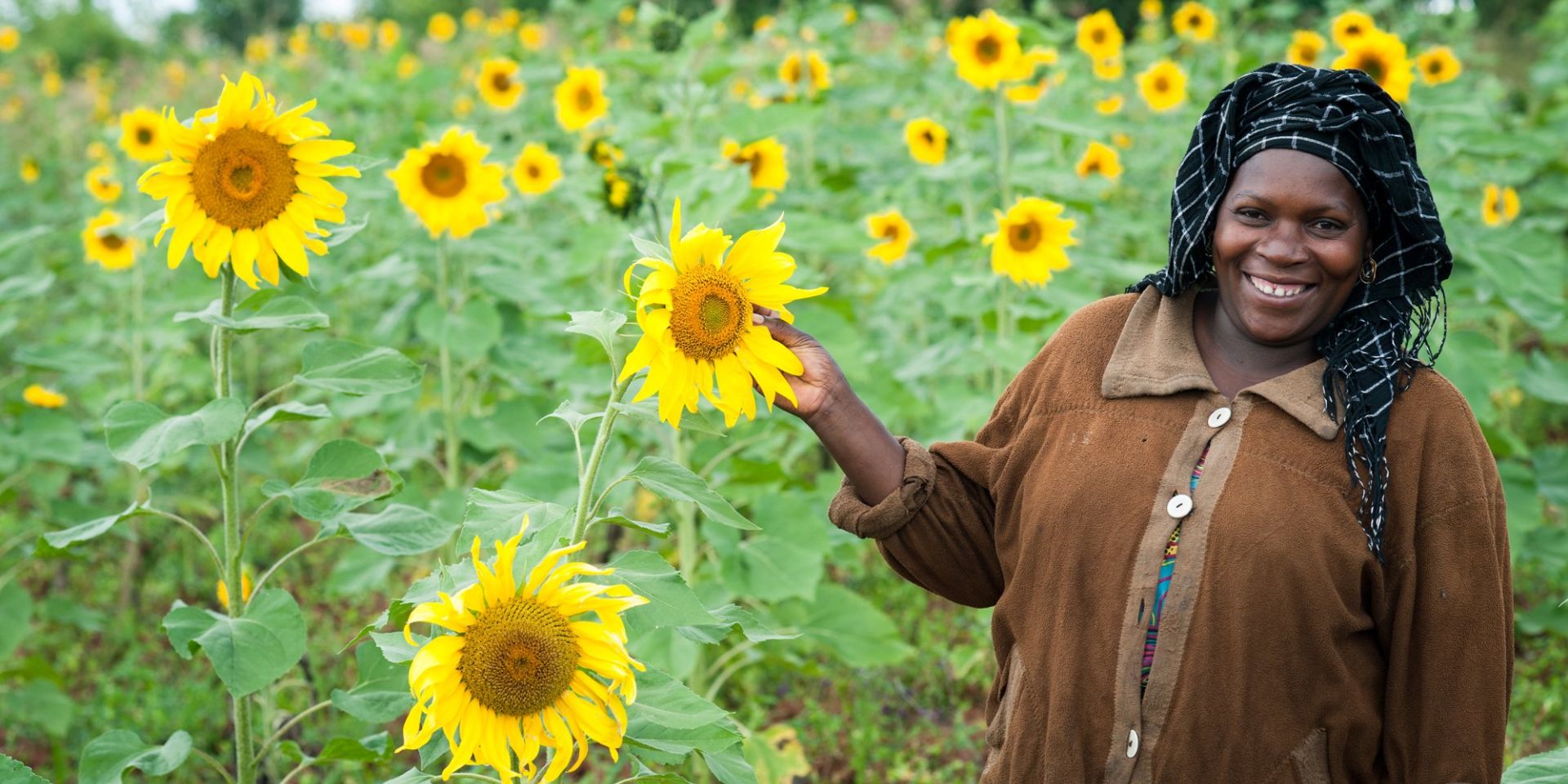 Female farmer showing off her sunflowers