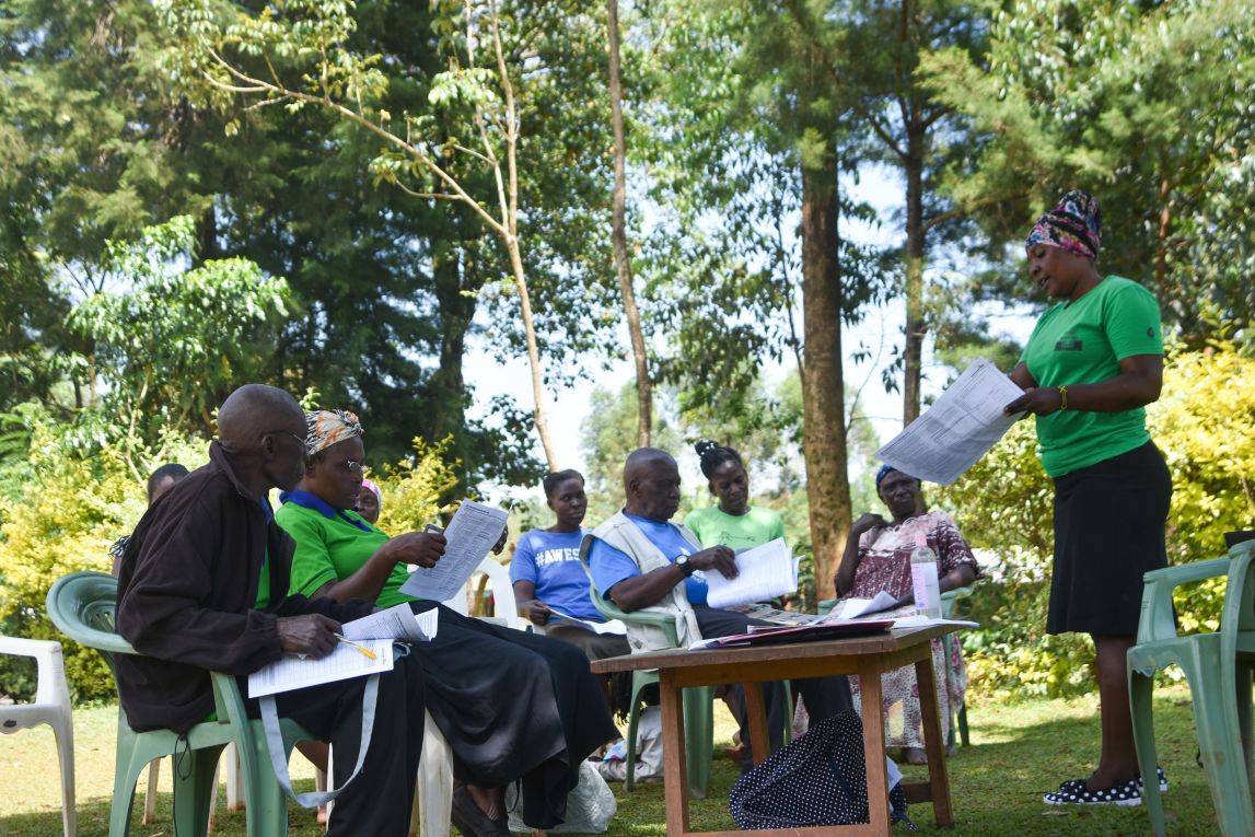 Annet Kasiti, one of our Field Officers in Western Kenya, takes a group of farmers through our product catalogue prior to enrolling them into our program.