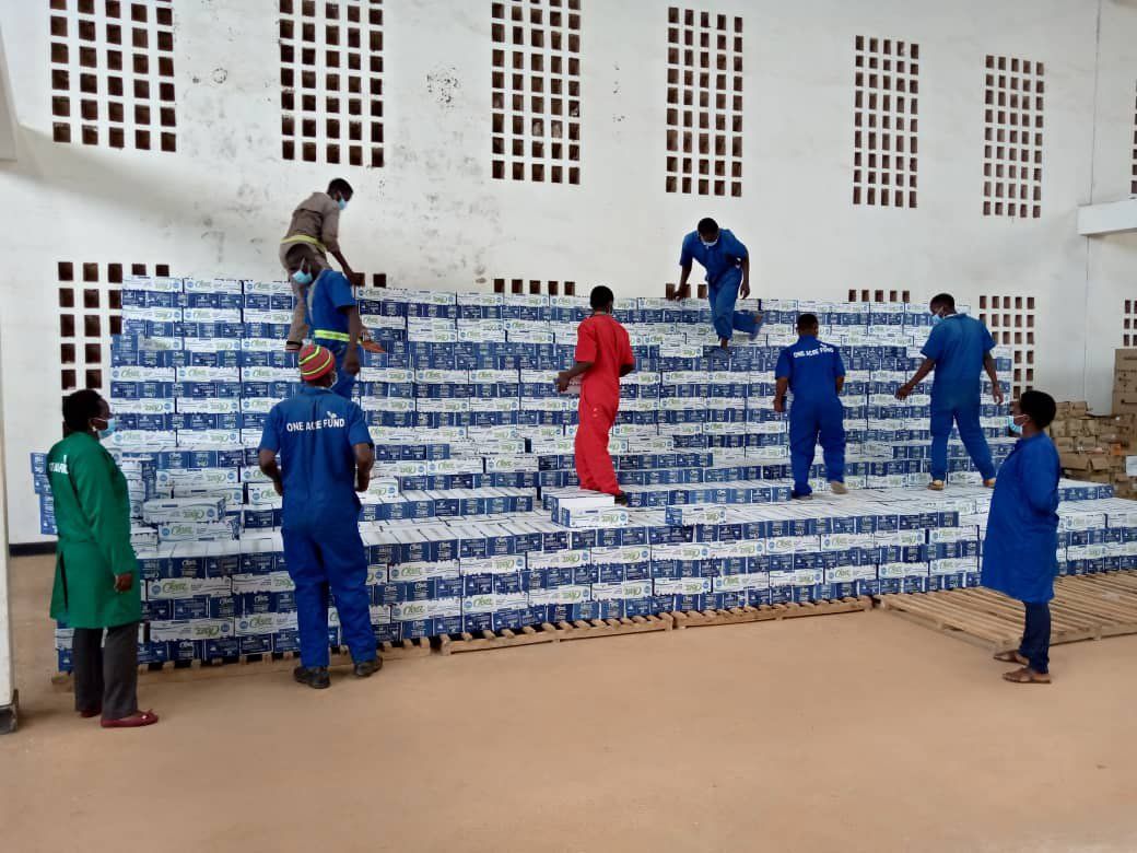 Workers unloading soap packages in a warehouse
